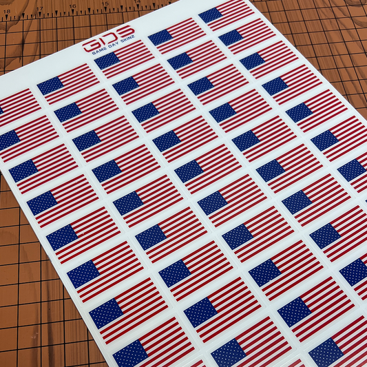 Sheet of American flags on a cutting mat with a ruler at the top.