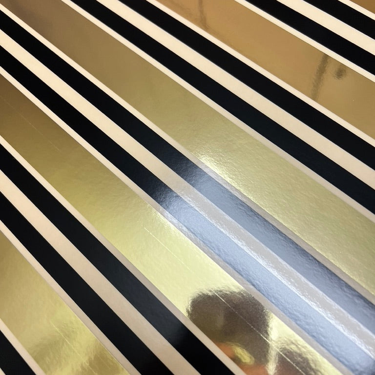Close-up of a metallic surface with black and gold stripes