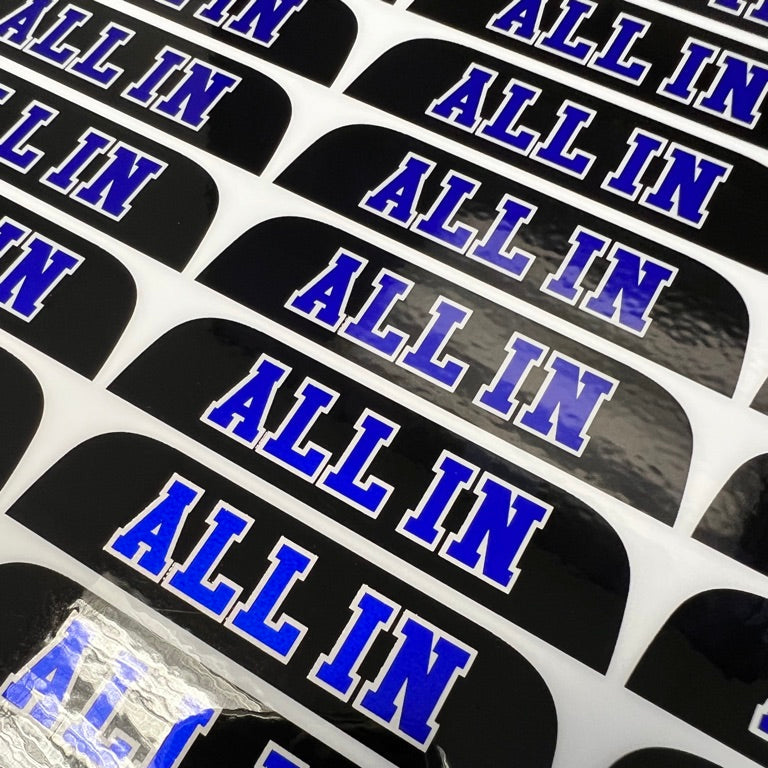 Multiple 'ALL IN' stickers with blue text on black background