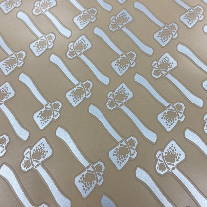 Pattern of white spatulas and ladles on a brown background