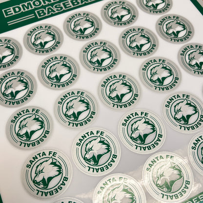 Sheet of baseball stickers with a green and white design on a cutting mat.