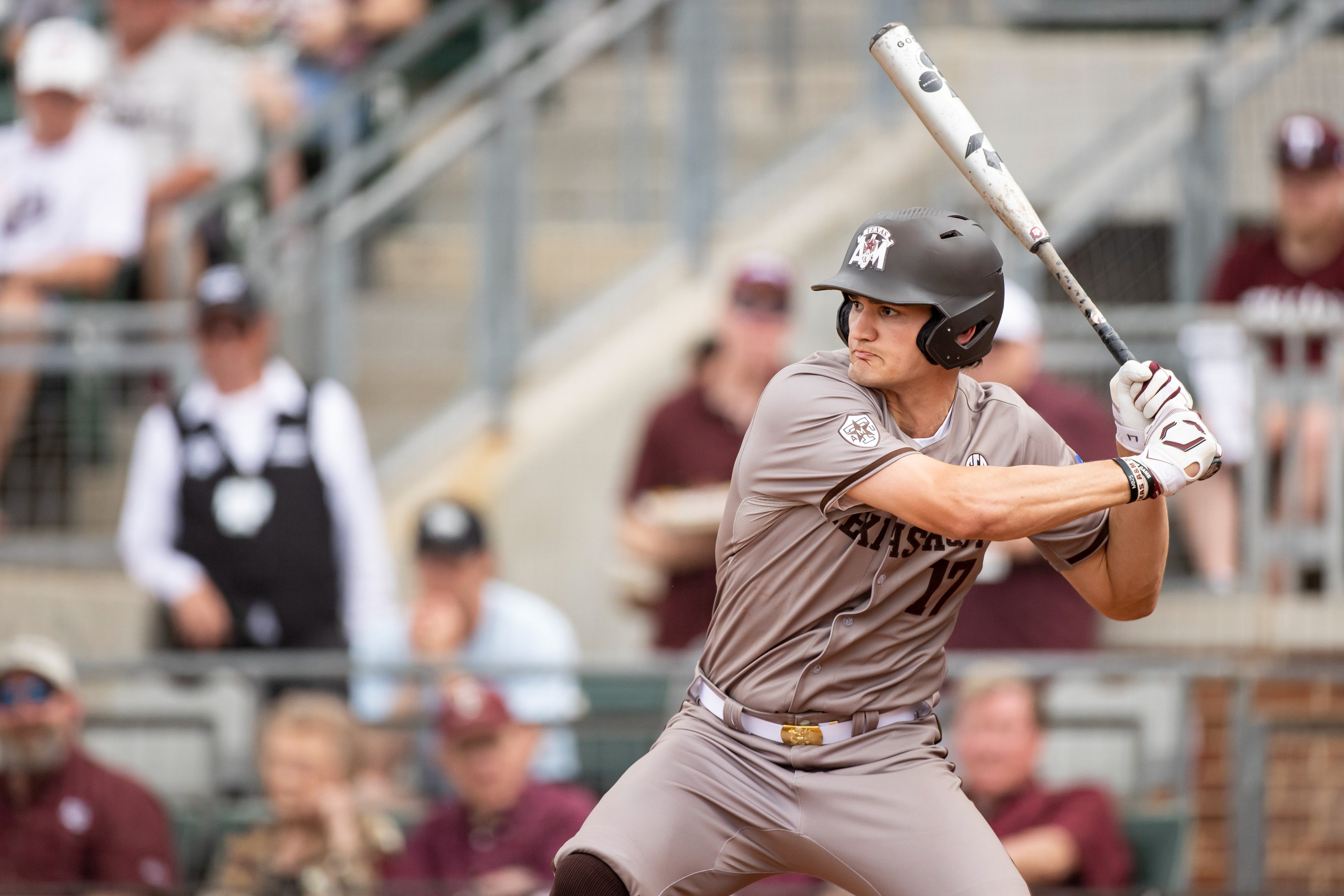 Baseball player in action during a game, swinging a bat.