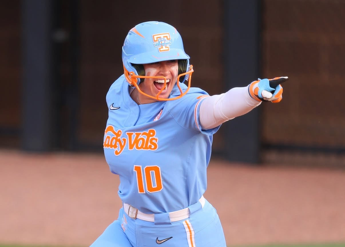 Baseball player in a blue uniform with 'Vols' and number 10 on a baseball field.