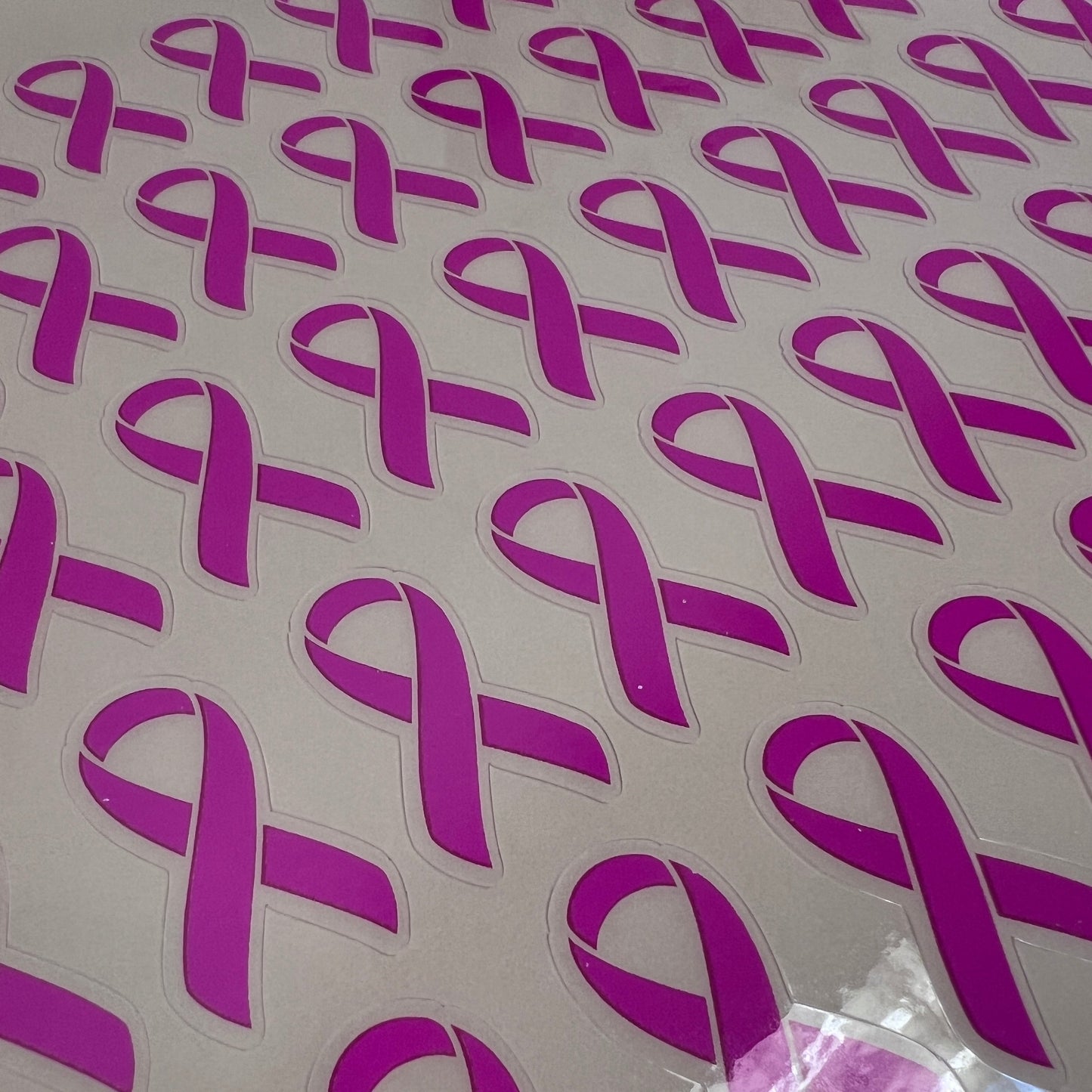 Purple ribbon stickers on a white background