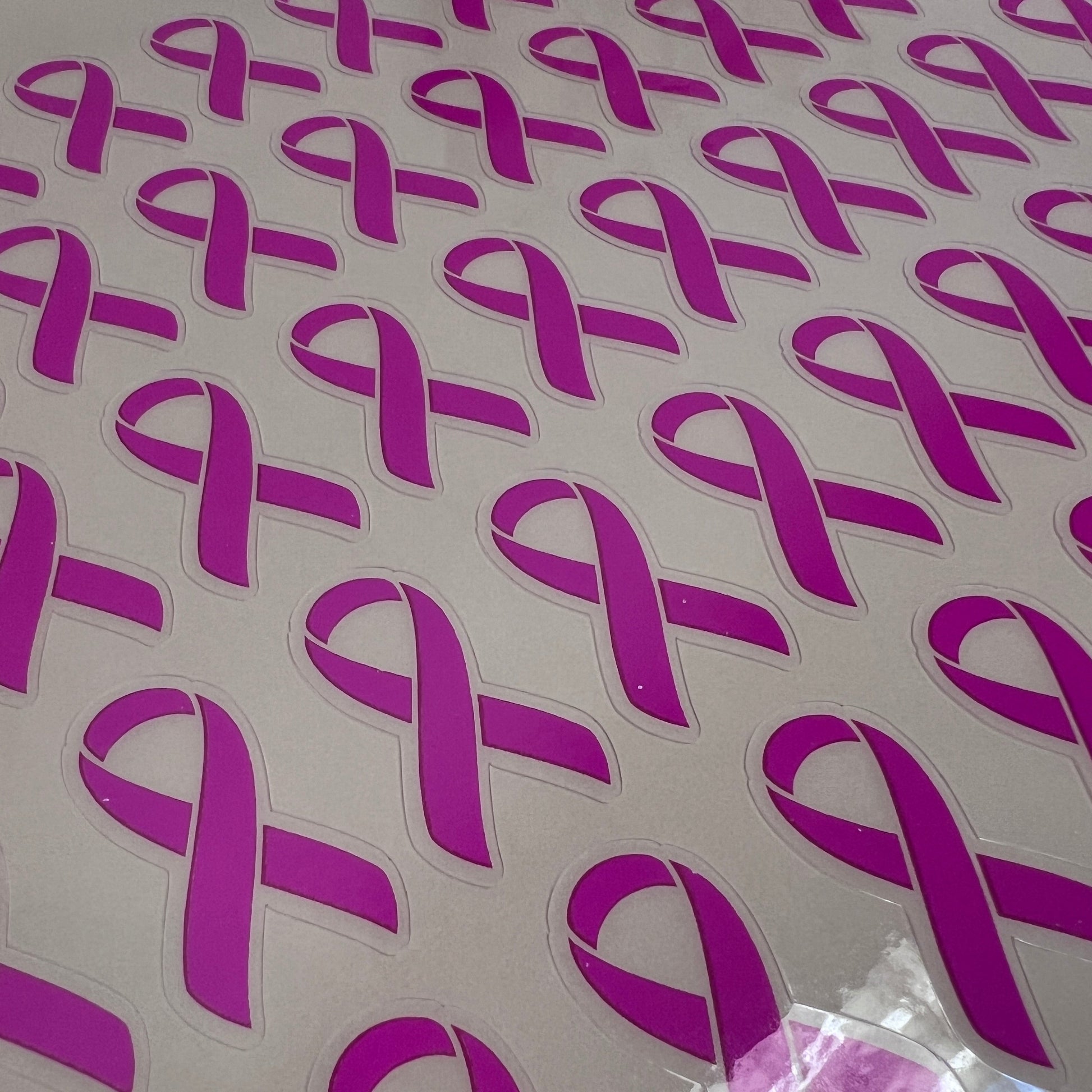 Purple ribbon stickers on a white background