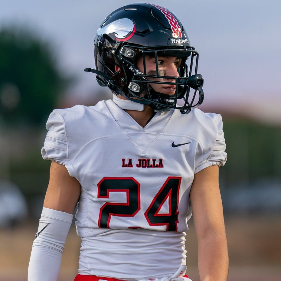 Person wearing a football uniform with 'La Jolla' and number 24 on a field.